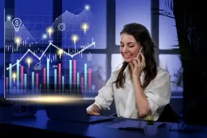 Person holding a smartphone with a futuristic transparent screen displaying candlestick charts, financial data, market analytics, and GS training online training elements.